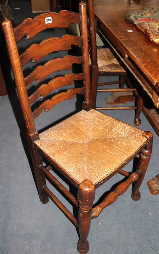 A set of four oak rush seated ladderback dining chairs